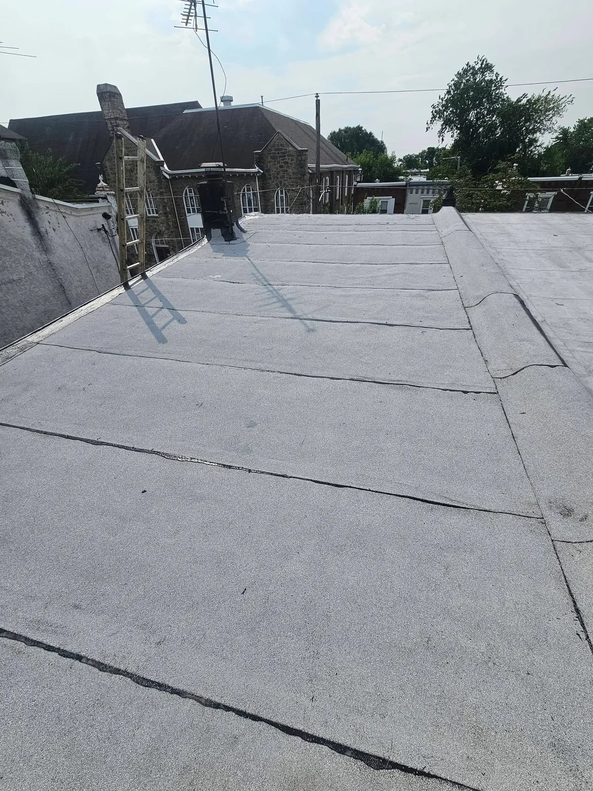 Flat roof membrane on a Brooklyn row house between parapet walls