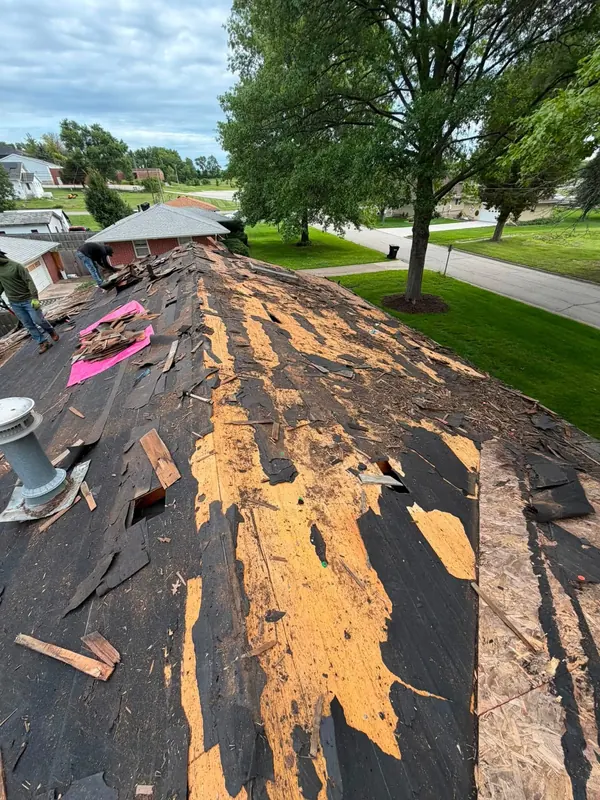 Old wood shake roof being stripped to the deck